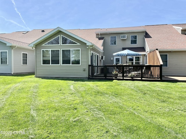 back of property featuring a lawn and a wooden deck