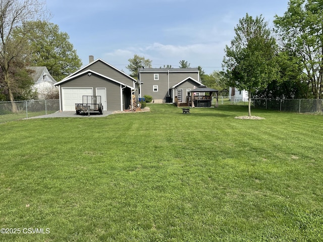 view of yard with fence and an outbuilding