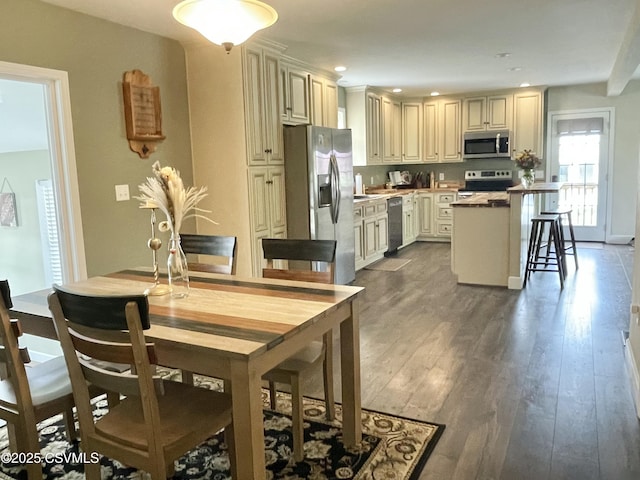 dining room featuring recessed lighting and dark wood-style floors