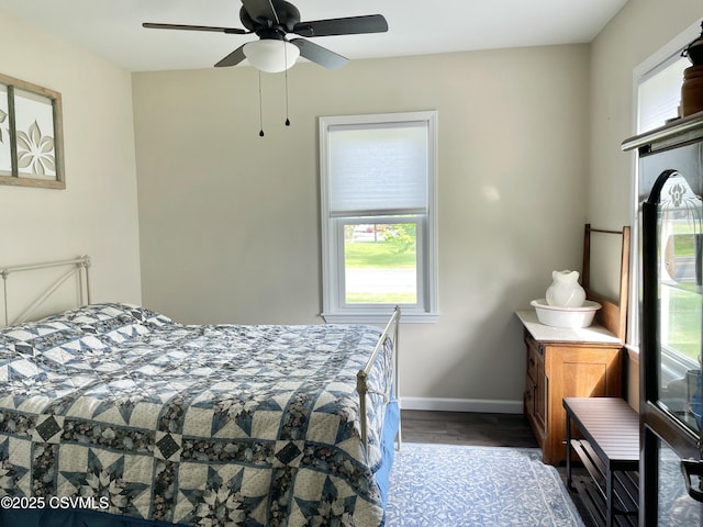 bedroom with baseboards, ceiling fan, and wood finished floors