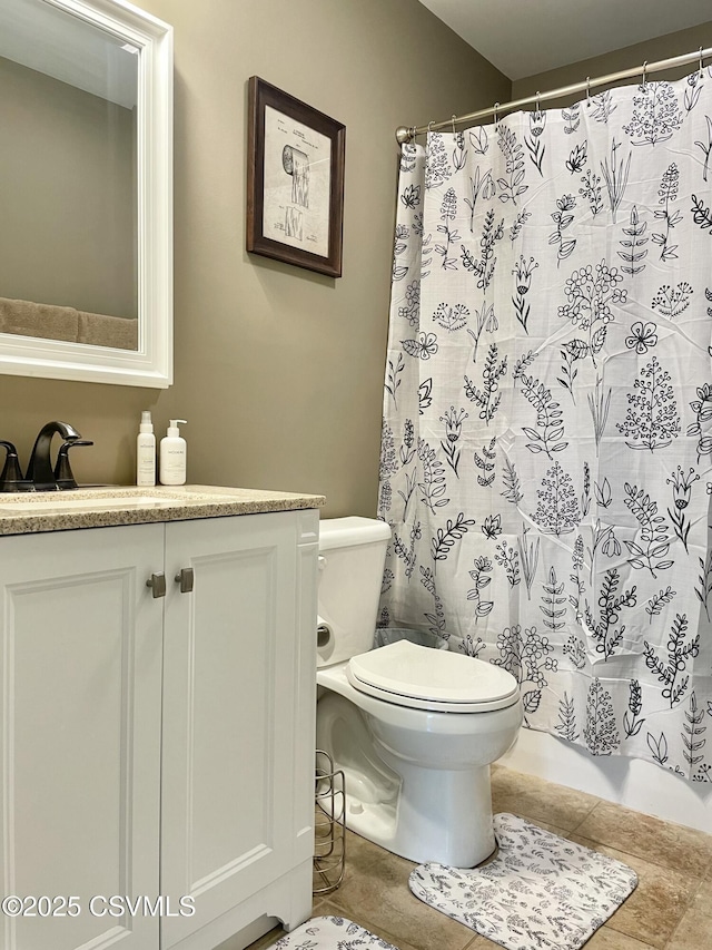 bathroom featuring vanity, tile patterned floors, toilet, and curtained shower
