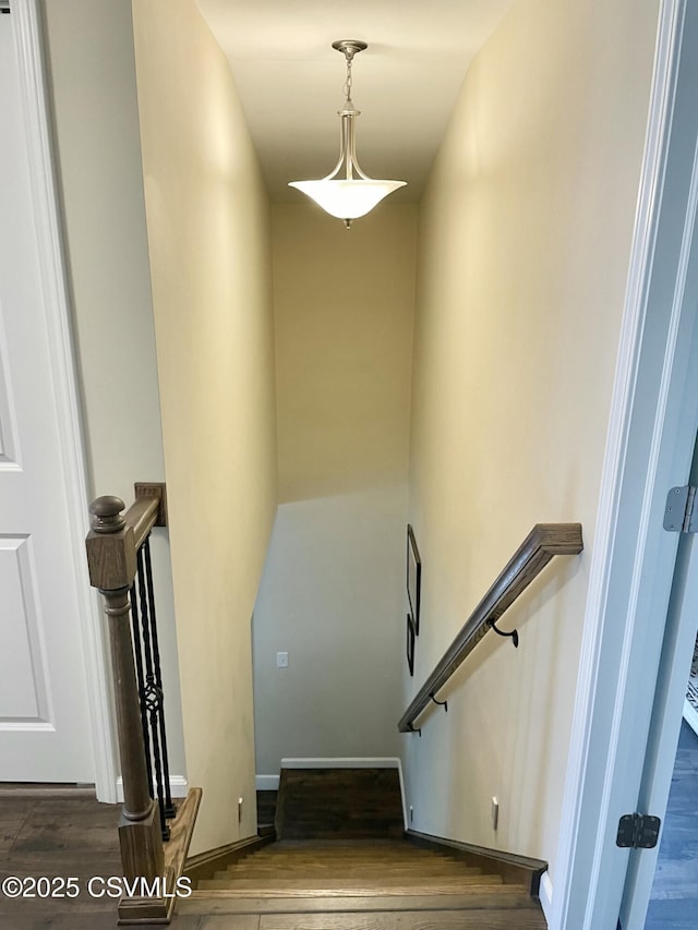 stairs featuring baseboards and wood finished floors
