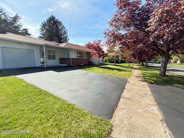 125 Knights Dr, Bloomsburg, PA 17815 - ranch-style house with aphalt driveway, a chimney, a front lawn, and a garage