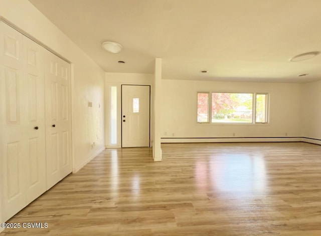 125 Knights Dr, Bloomsburg, PA 17815 - foyer entrance featuring baseboards, light wood-style flooring, and a baseboard heating unit