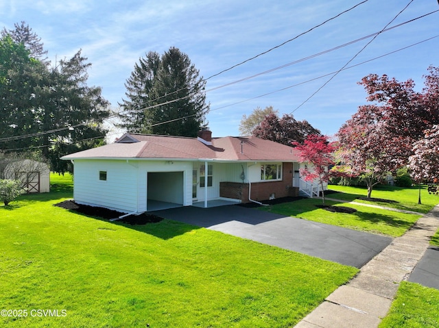 125 Knights Dr, Bloomsburg, PA 17815 - view of front facade with an attached garage, a chimney, driveway, and a front lawn