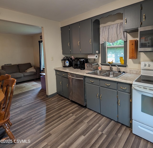 705 N 7th St, Sunbury, PA 17801 - kitchen with stainless steel appliances, a sink, dark wood-type flooring, light countertops, and open floor plan