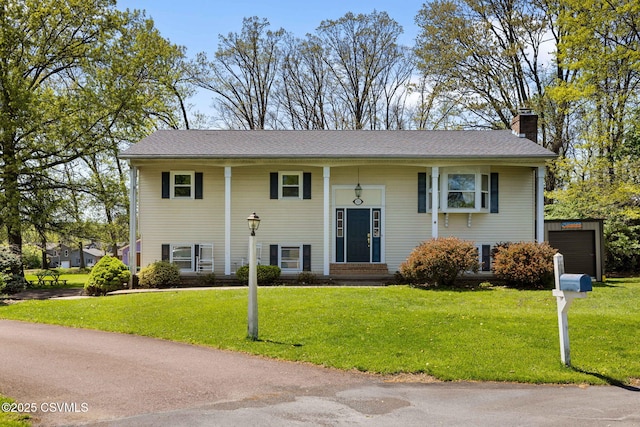 31 Holly Ct, Danville, PA 17821 - split foyer home with a chimney, entry steps, a front lawn, and a garage