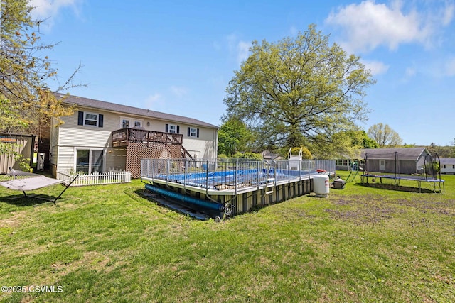 31 Holly Ct, Danville, PA 17821 - back of property with a yard, a trampoline, and a fenced in pool