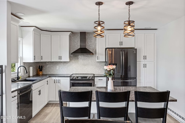 31 Holly Ct, Danville, PA 17821 - kitchen with a baseboard heating unit, light wood finished floors, a sink, wall chimney exhaust hood, and appliances with stainless steel finishes