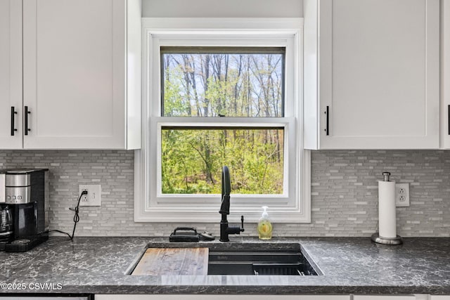 31 Holly Ct, Danville, PA 17821 - kitchen featuring decorative backsplash, white cabinets, and a sink