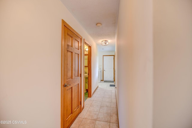 hall with light tile patterned floors