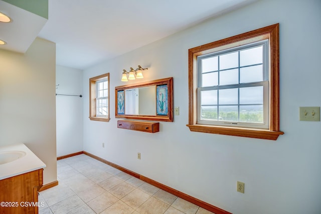 bathroom featuring baseboards, vanity, and tile patterned flooring