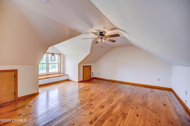 bonus room with ceiling fan, light wood-type flooring, baseboards, and lofted ceiling
