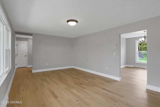 92 Valley View Rd, Lewisburg, PA 17837 - spare room with an inviting chandelier, light wood-style flooring, baseboards, and a baseboard heating unit