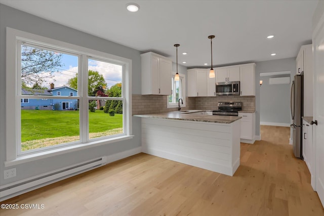 92 Valley View Rd, Lewisburg, PA 17837 - kitchen featuring a peninsula, light wood finished floors, a sink, appliances with stainless steel finishes, and a baseboard radiator