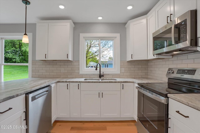 92 Valley View Rd, Lewisburg, PA 17837 - kitchen with a sink, stainless steel appliances, white cabinetry, and a wealth of natural light