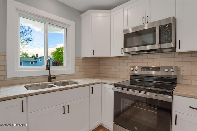 92 Valley View Rd, Lewisburg, PA 17837 - kitchen with white cabinets, appliances with stainless steel finishes, decorative backsplash, and a sink