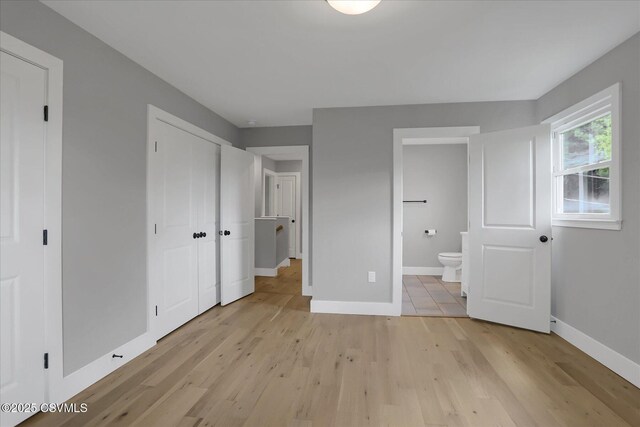 92 Valley View Rd, Lewisburg, PA 17837 - unfurnished bedroom with a closet, light wood-type flooring, ensuite bath, and baseboards