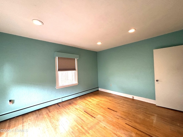735 E 3rd St, Bloomsburg, PA 17815 - spare room featuring wood finished floors, a baseboard heating unit, recessed lighting, and baseboards