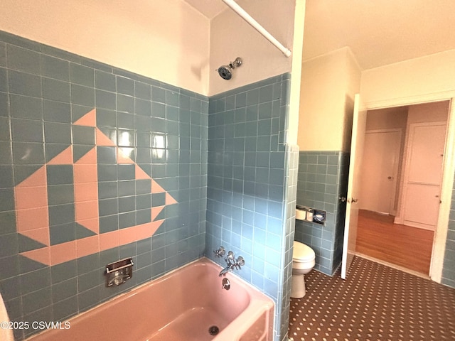 735 E 3rd St, Bloomsburg, PA 17815 - bathroom featuring tile walls, toilet, a tub, a shower, and a wainscoted wall