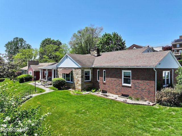 735 E 3rd St, Bloomsburg, PA 17815 - back of property with a lawn, a chimney, brick siding, and a shingled roof