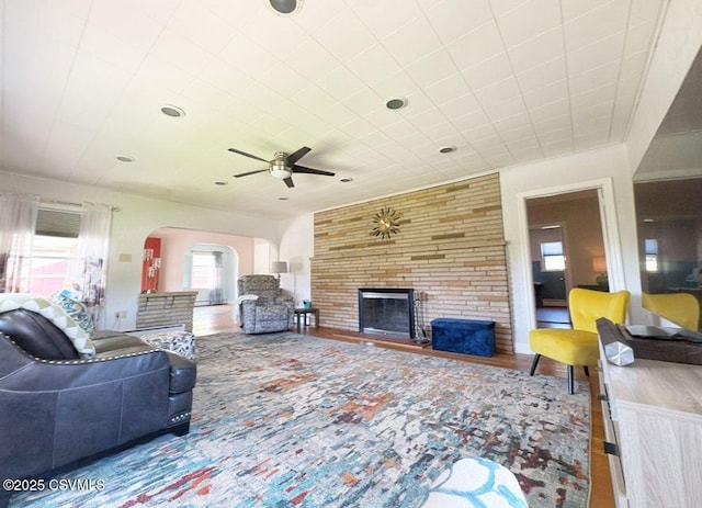 735 E 3rd St, Bloomsburg, PA 17815 - living room featuring a fireplace, arched walkways, and ceiling fan