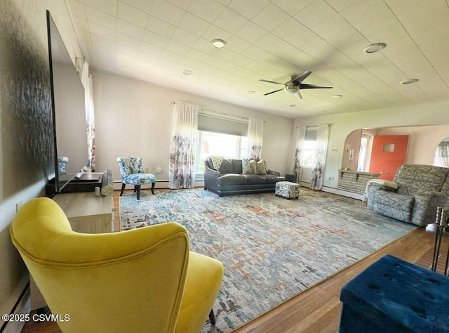 735 E 3rd St, Bloomsburg, PA 17815 - living room with arched walkways, ceiling fan, wood finished floors, and baseboard heating