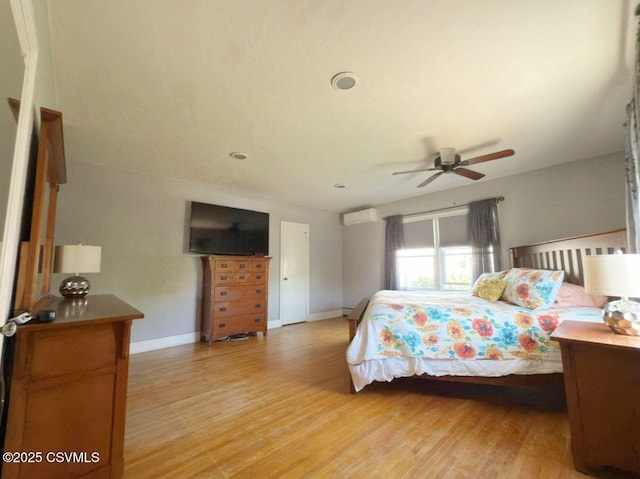 735 E 3rd St, Bloomsburg, PA 17815 - bedroom with an AC wall unit, light wood-style flooring, and baseboards