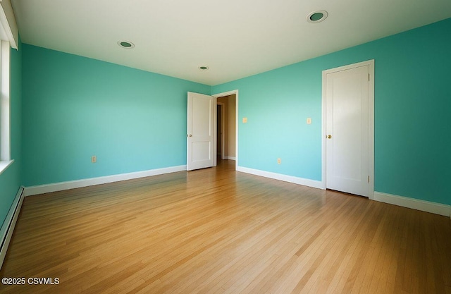 735 E 3rd St, Bloomsburg, PA 17815 - spare room with wood finished floors, baseboards, a baseboard radiator, and recessed lighting