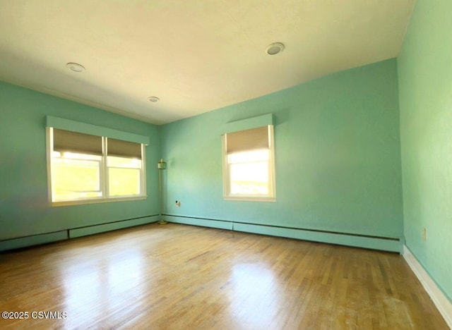 735 E 3rd St, Bloomsburg, PA 17815 - spare room with wood finished floors, a baseboard radiator, and baseboards