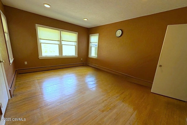 735 E 3rd St, Bloomsburg, PA 17815 - unfurnished room featuring a baseboard radiator, wood finished floors, baseboards, and recessed lighting