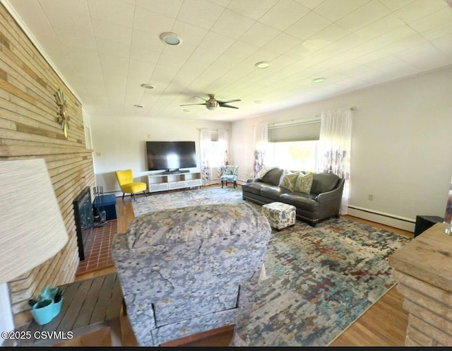 735 E 3rd St, Bloomsburg, PA 17815 - living area featuring baseboard heating, wood finished floors, and ceiling fan