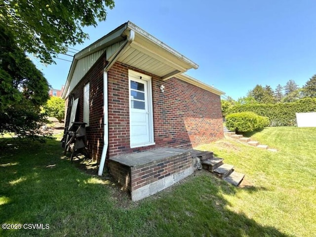 735 E 3rd St, Bloomsburg, PA 17815 - view of property exterior with brick siding and a lawn
