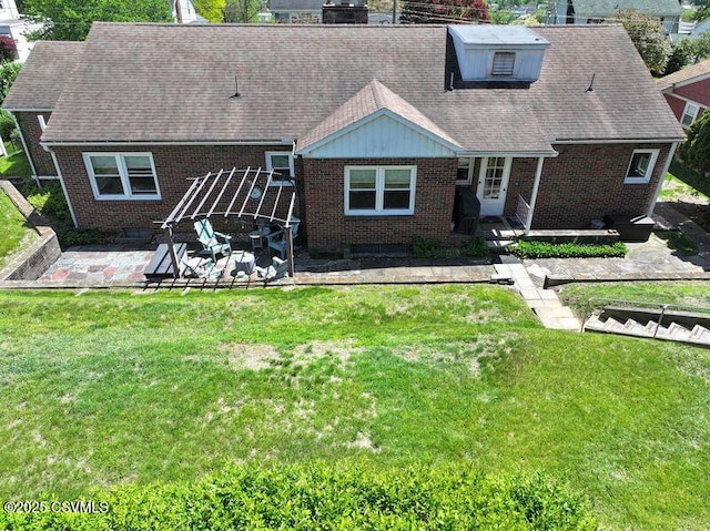 735 E 3rd St, Bloomsburg, PA 17815 - rear view of house with a patio, brick siding, a lawn, and roof with shingles
