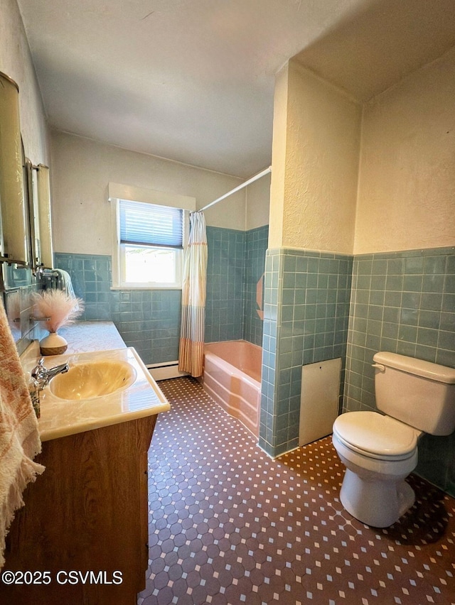 735 E 3rd St, Bloomsburg, PA 17815 - full bath with tile walls, toilet, vanity, shower / tub combo with curtain, and a wainscoted wall