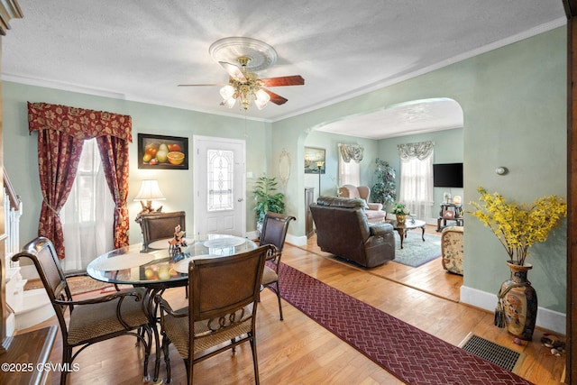 341 Dewart St, Danville, PA 17821 - dining area featuring arched walkways, a ceiling fan, plenty of natural light, crown molding, and a textured ceiling