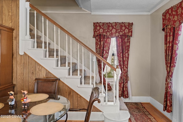 341 Dewart St, Danville, PA 17821 - foyer entrance featuring wood finished floors, plenty of natural light, stairs, crown molding, and baseboards