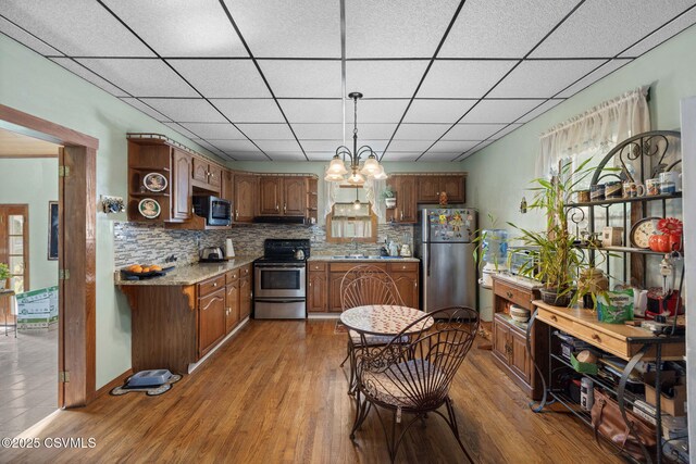 341 Dewart St, Danville, PA 17821 - kitchen featuring stainless steel appliances, a sink, wood finished floors, light countertops, and tasteful backsplash