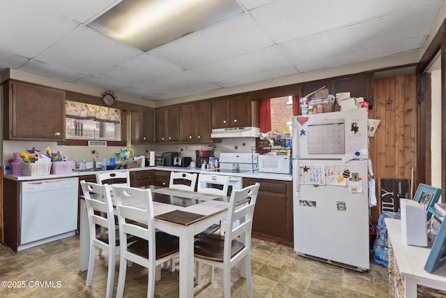 276 3rd St, New Columbia, PA 17856 - kitchen with white appliances, light countertops, a paneled ceiling, under cabinet range hood, and dark brown cabinets