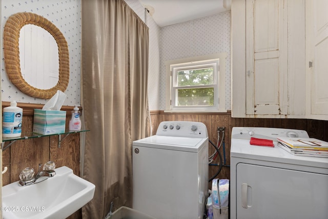 276 3rd St, New Columbia, PA 17856 - washroom with wallpapered walls, washing machine and clothes dryer, a sink, a wainscoted wall, and wooden walls
