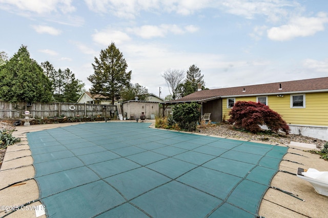 view of swimming pool with fence and a patio