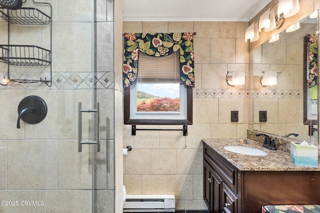 bathroom with ornamental molding, a baseboard heating unit, a stall shower, vanity, and tile walls