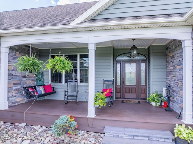 357 Lick Run Rd, Bloomsburg, PA 17815 - view of exterior entry with a shingled roof, covered porch, and stone siding