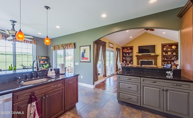 357 Lick Run Rd, Bloomsburg, PA 17815 - kitchen with a sink, dark countertops, arched walkways, a fireplace, and lofted ceiling