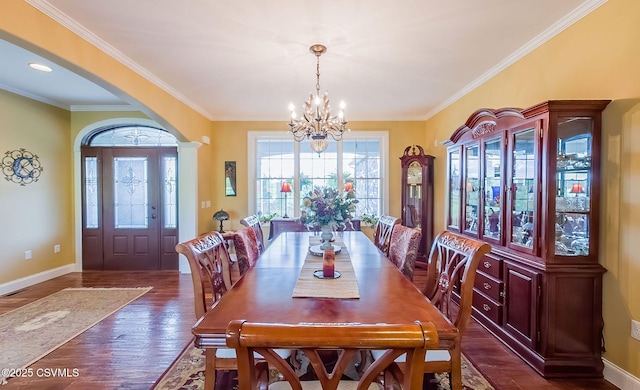 357 Lick Run Rd, Bloomsburg, PA 17815 - dining space featuring a chandelier, arched walkways, dark wood-type flooring, baseboards, and crown molding