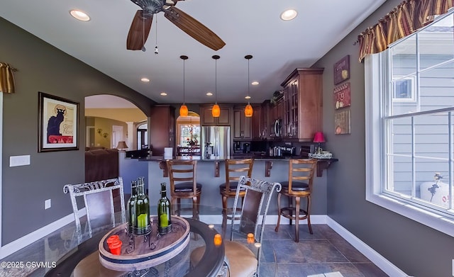 357 Lick Run Rd, Bloomsburg, PA 17815 - bar featuring stainless steel refrigerator with ice dispenser, arched walkways, healthy amount of natural light, a ceiling fan, and recessed lighting