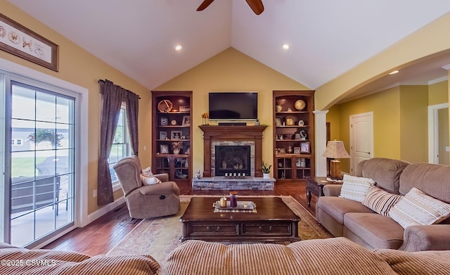 357 Lick Run Rd, Bloomsburg, PA 17815 - living room with ceiling fan, arched walkways, built in shelves, a stone fireplace, and wood finished floors