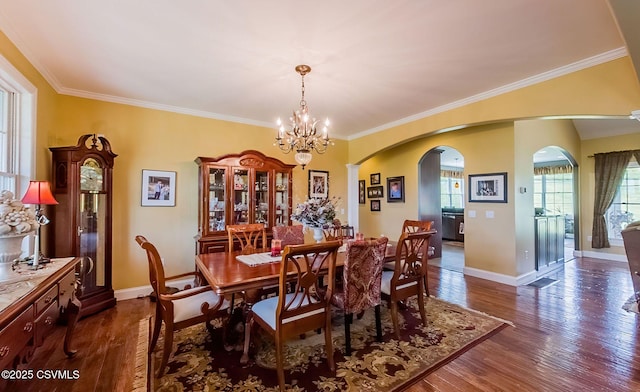 357 Lick Run Rd, Bloomsburg, PA 17815 - dining space featuring arched walkways, a chandelier, dark wood-style flooring, baseboards, and crown molding