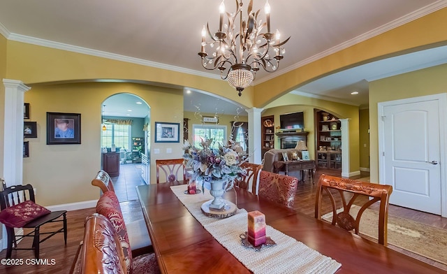 357 Lick Run Rd, Bloomsburg, PA 17815 - dining room with arched walkways, crown molding, baseboards, wood finished floors, and decorative columns