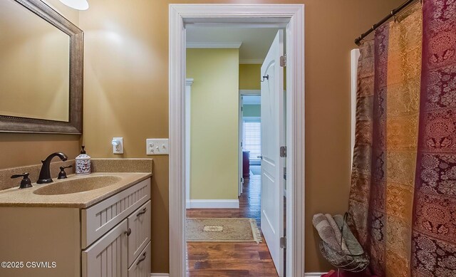 357 Lick Run Rd, Bloomsburg, PA 17815 - bathroom with crown molding, wood finished floors, vanity, and baseboards